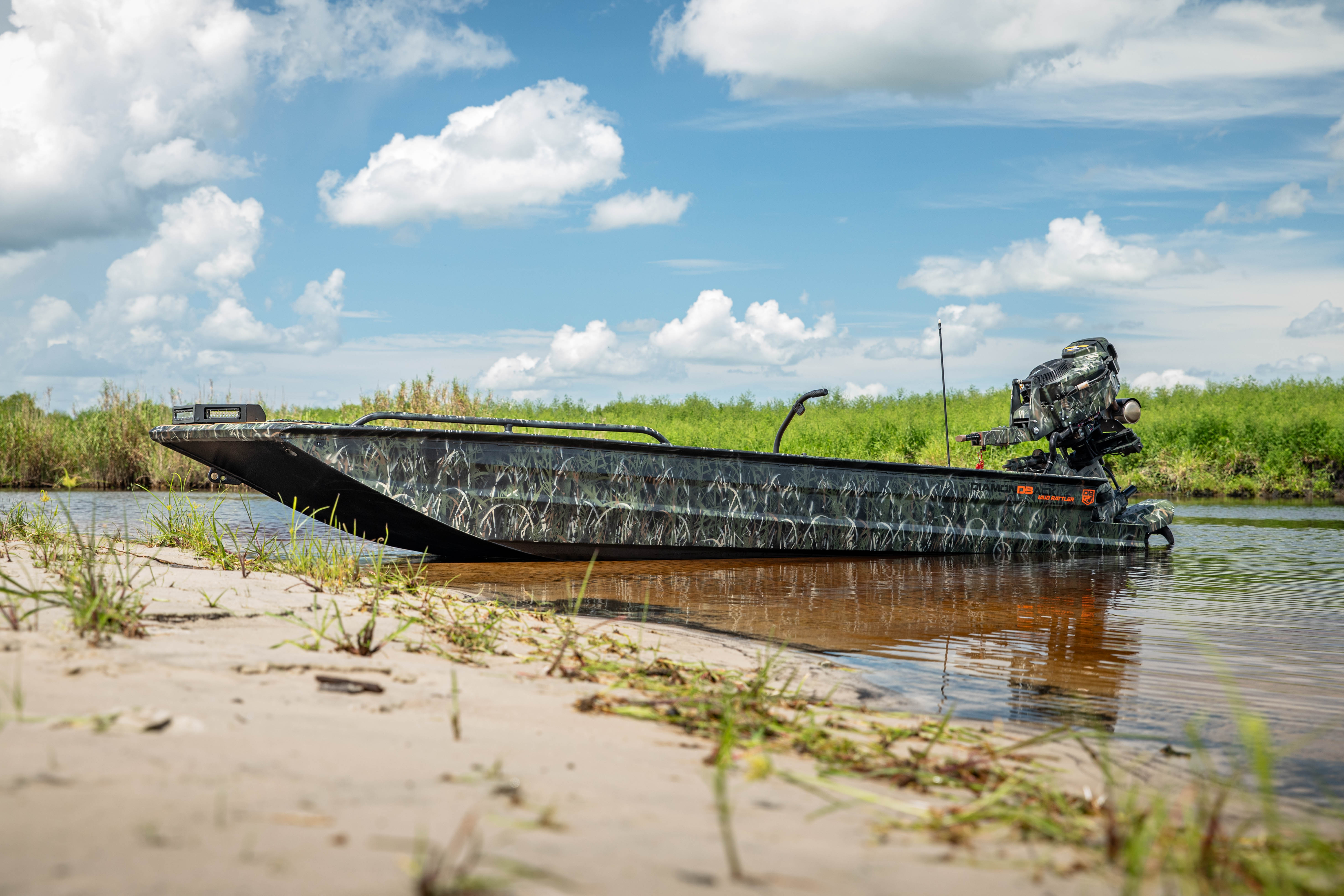 Camo boat on open water at sunset